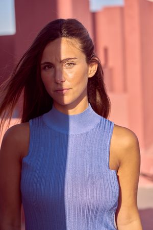 Woman looking at camera in sunlight