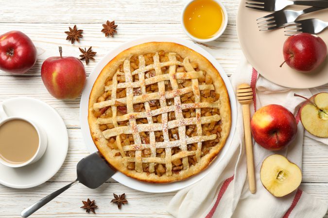Composition with apple pie and ingredients on wooden background, top view