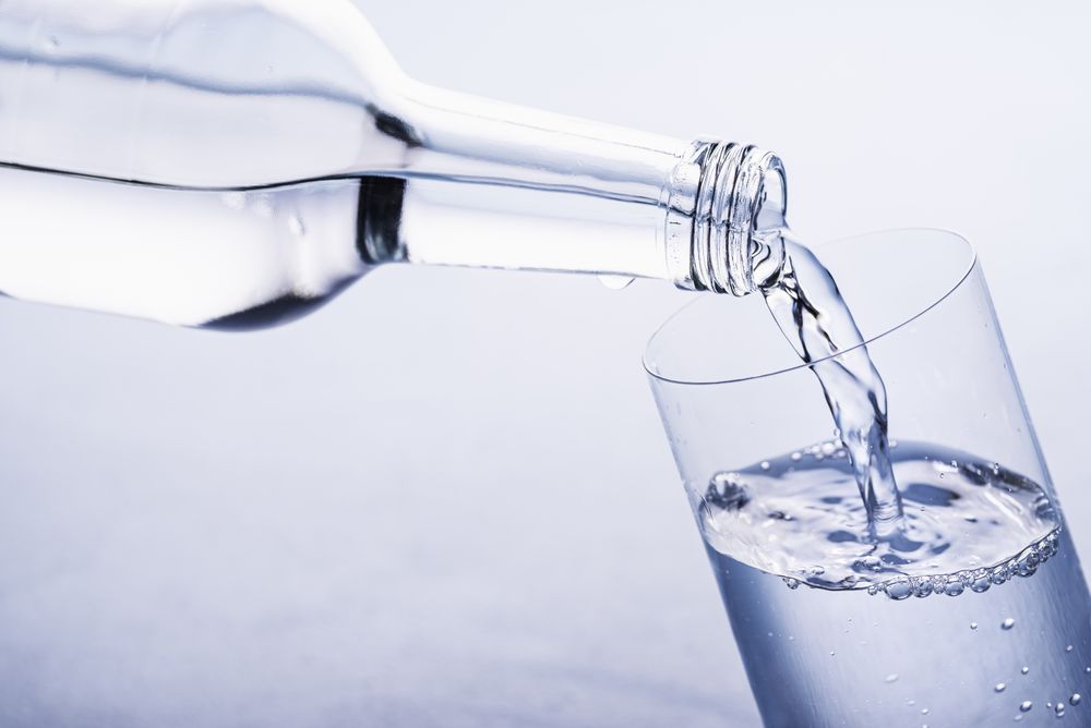 Pouring still water in a glass