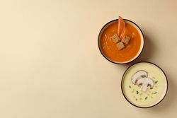 Sweet potato and mushroom soup on beige background with copy space