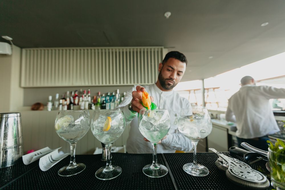 Cheerful Barman preparing alcoholic drinks in a bar.