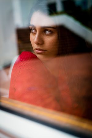 Young charming woman near window