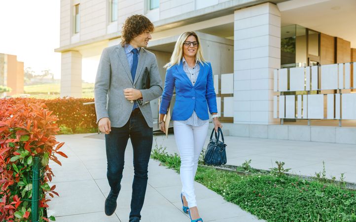 Businessman and businesswoman leaving the office