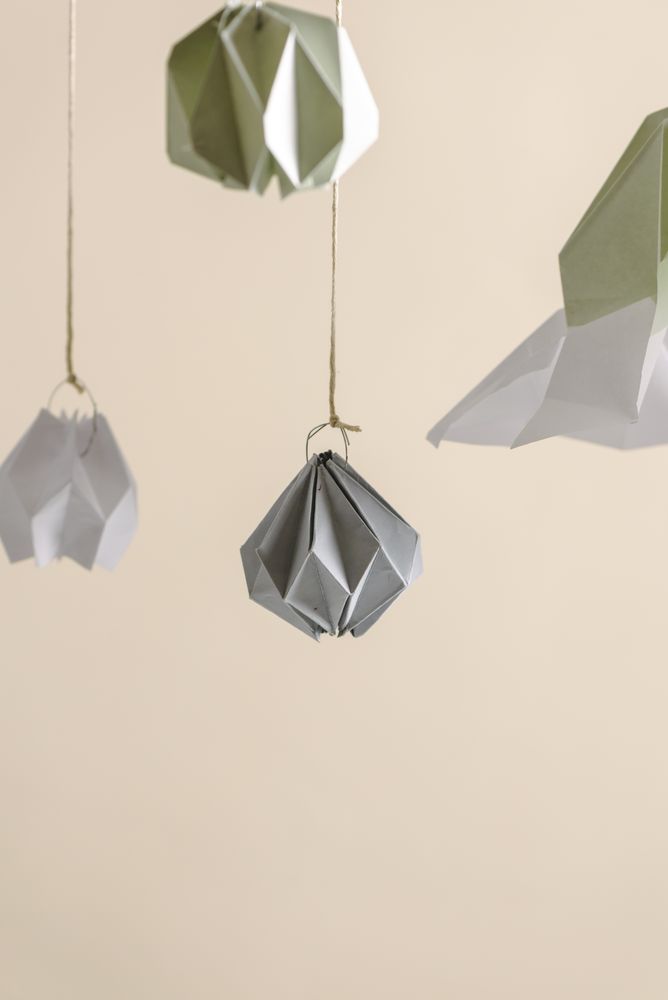 Christmas decor interior origami paper, ornament hanging on pastel threads