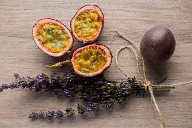 Juicy sliced passion fruit and bunch of lavender