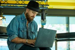 man seriously typing on laptop