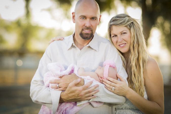 Content Couple Holding Their Newborn Baby Girl