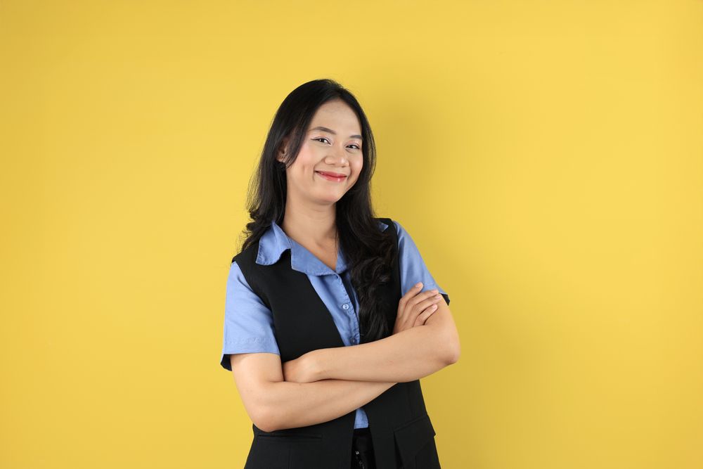 Asian Young Women  Standing Confident with Arms Crossed, Smiling Pleased