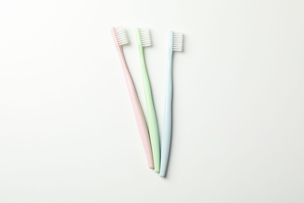 Toothbrushes on light background, top view. Dental care