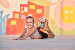 Smiling child resting on street in sunlight
