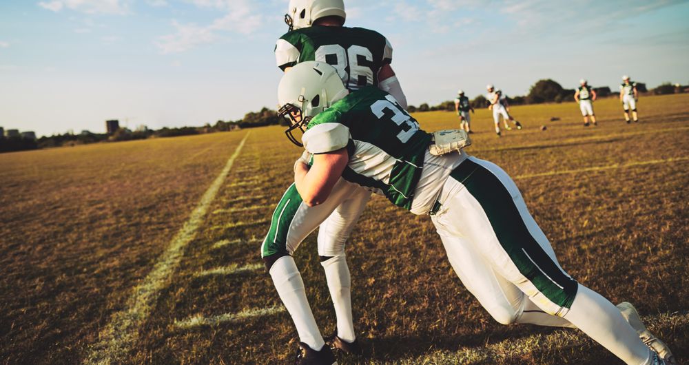 Men practicing drills during football practice