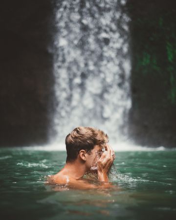 Man swimming in turquoise natural bay