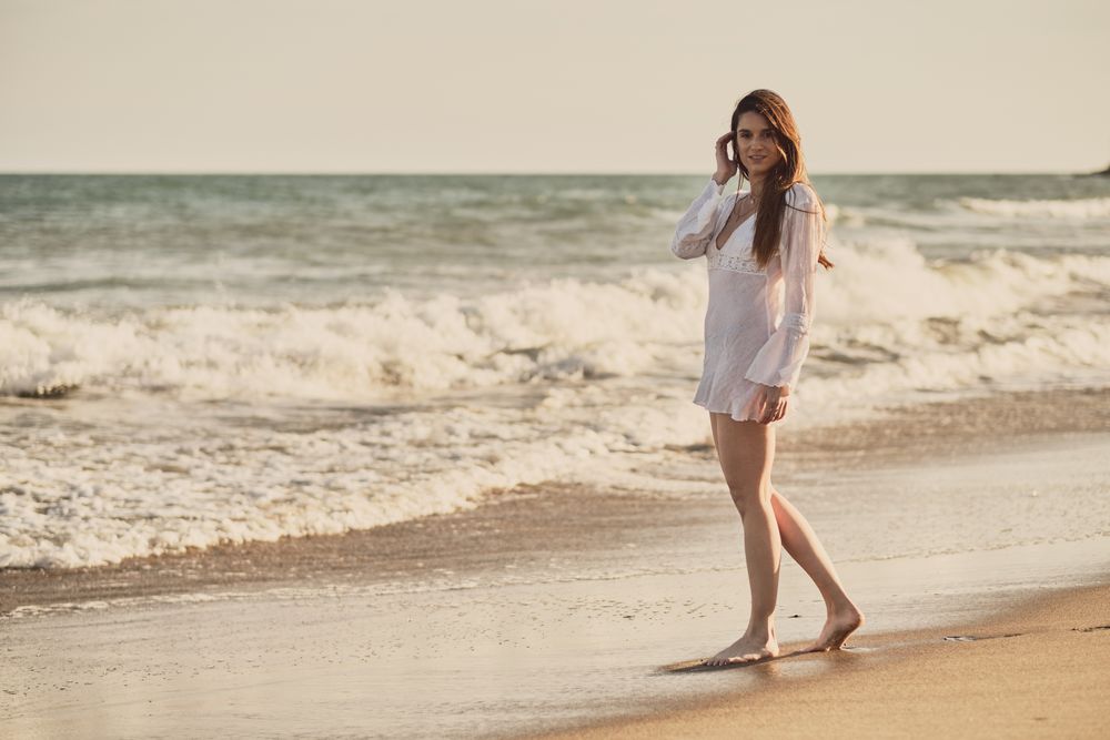 Woman with white dress at the beach
