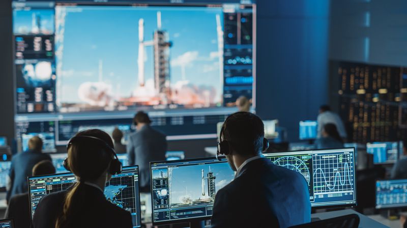 Space Mission Control Room Monitors Rocket Launch.