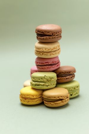Front view of pile of colorful macaroons on a marble background