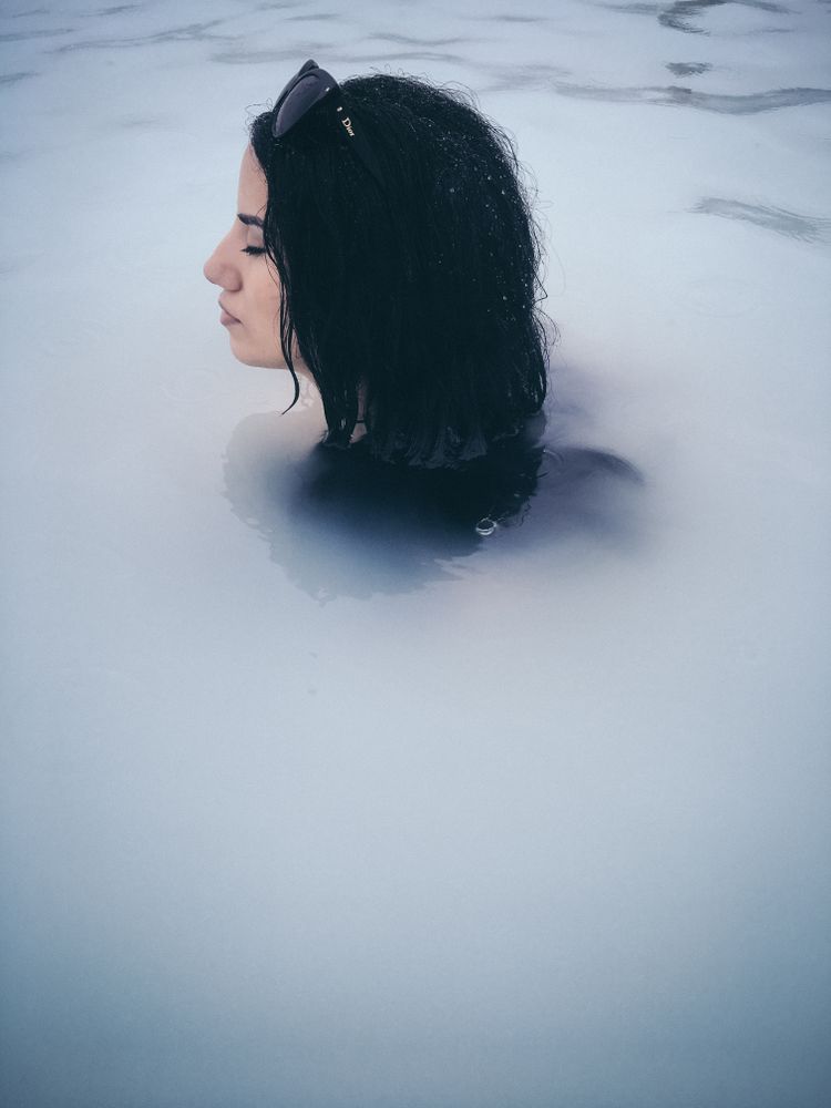Woman submerged in hot spring