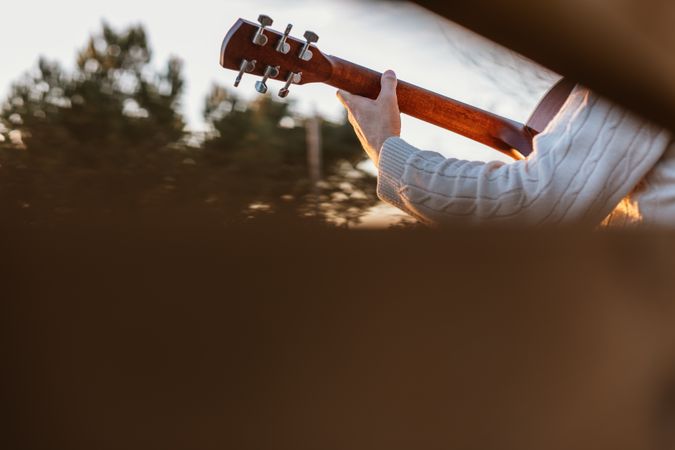 Man playing the guitar on the outside