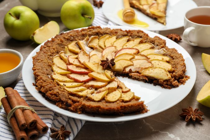 Composition with apple pie and ingredients on gray background. Homemade food