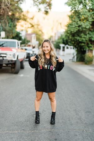 Woman in dark sweater posing outdoor