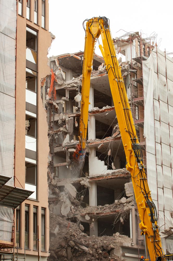 Yellow crane beside crumbling building