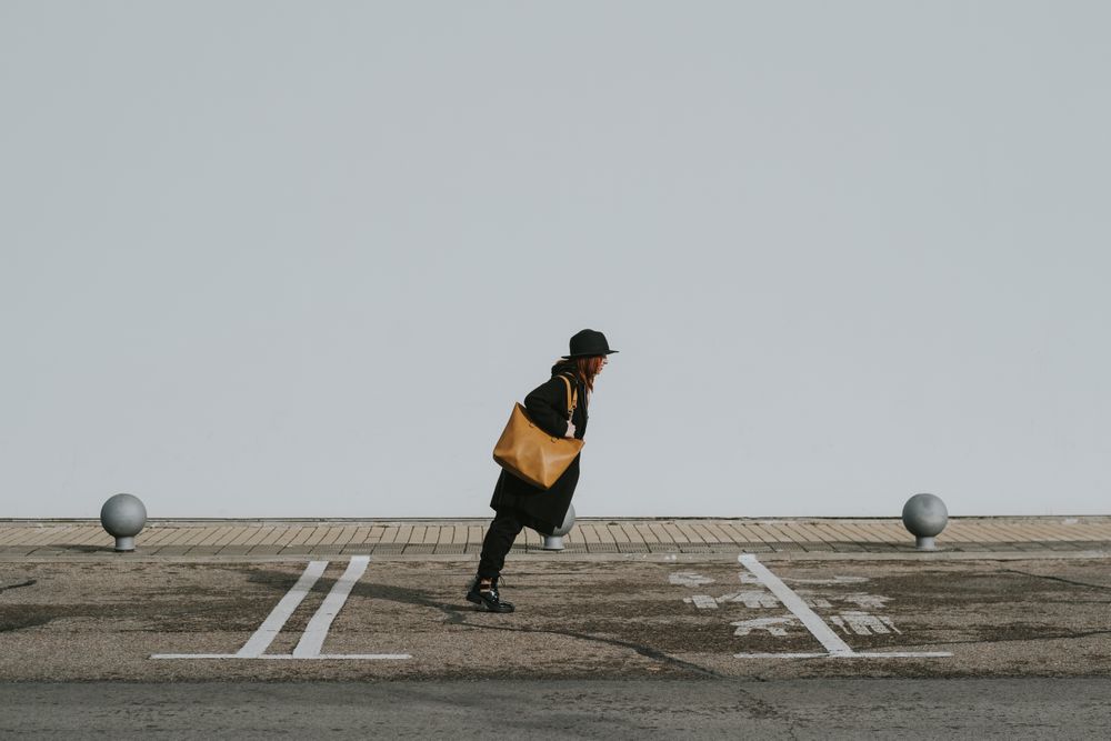 Woman balancing on street parking