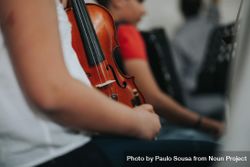 Students sitting in a row and holding violin 48P2Y4