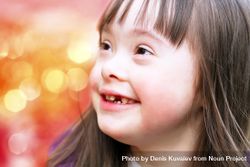 Closeup portrait of smiling young girl with Down syndrome outside 5aE6W5