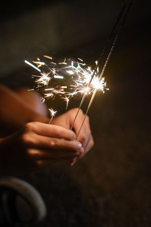 Unrecognizable person with sparkling Bengal lights