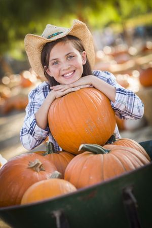 Preteen Girl Playing at the Pumpkin Patch.