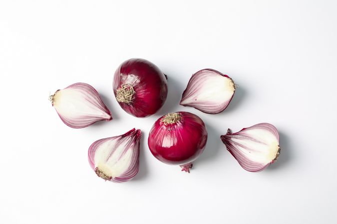 Flat lay composition with red onion and spices on blank background