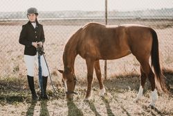 Teen girl with horse on ranch