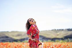 Excited woman laughing in field