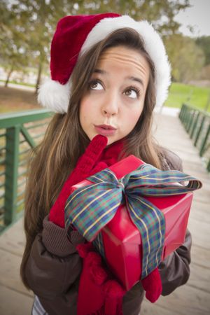 Woman Wearing a Santa Hat with Gift