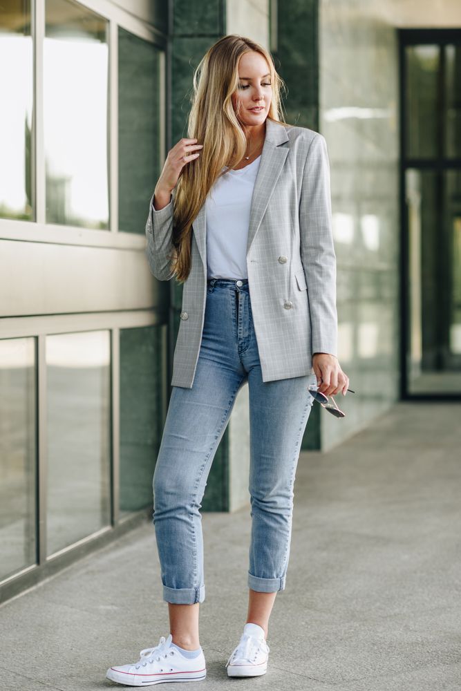 Woman in blazer walking outside offices