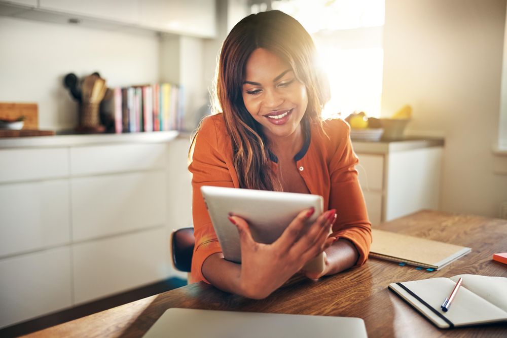 Businesswoman smiling at her tablet screen