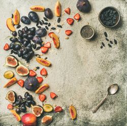 Fruit assortment with figs, grapes, peaches, strawberries, and chia seeds, square crop, copy space
