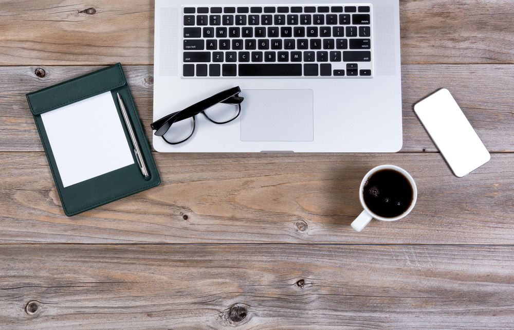 Flat view of working desktop with mobile devices and dark coffee