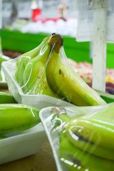 Banana fruits wrapped and for sale in store