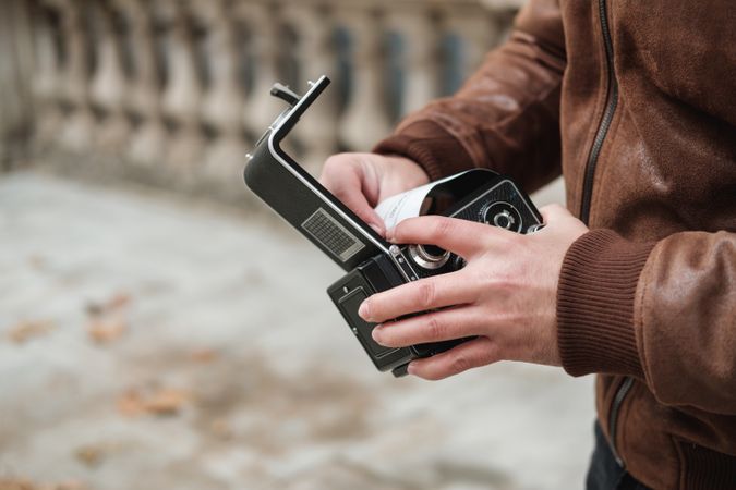 Crop traveler changing film in camera