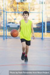 Teenager playing basketball on an outdoors court 0L6vg4
