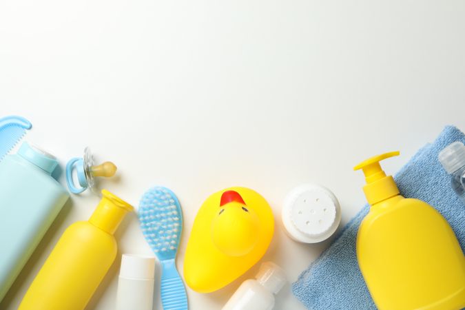 Baby hygiene accessories on light background, top view and space for text