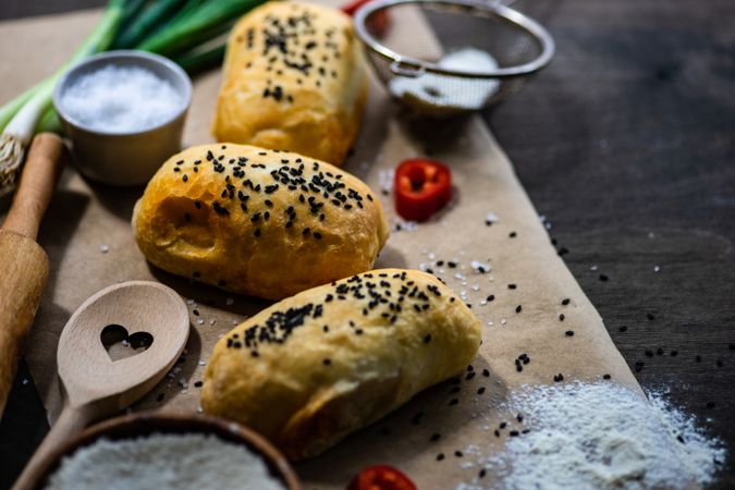 Traditional Georgian pies with chicken meat, bell pepper and herbs with flour and sieve