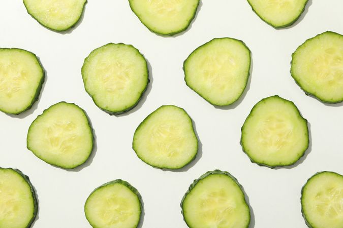 Cucumber slices on blank background, top view