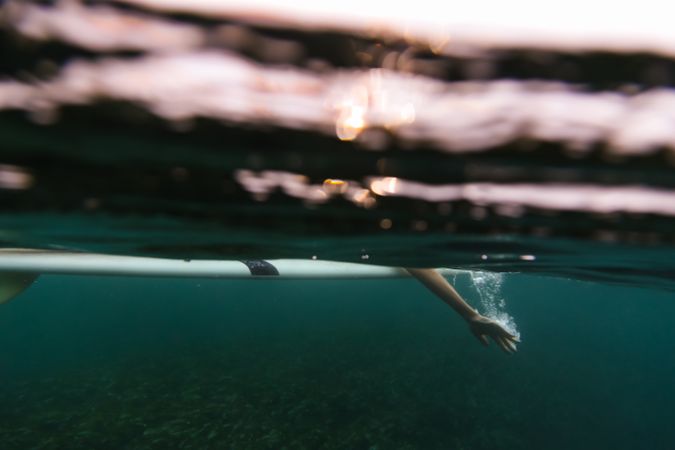 Woman on surf board floating on water
