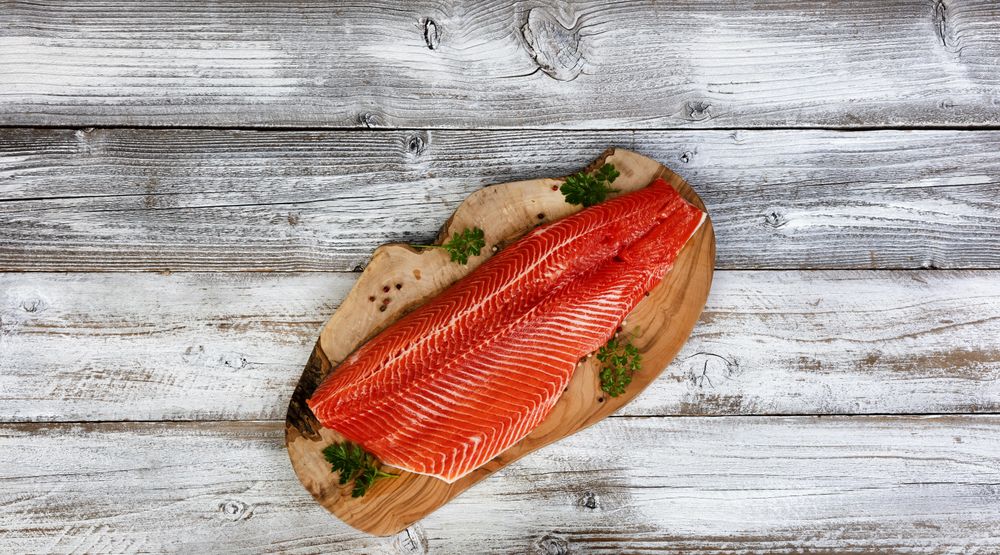Rainbow trout fillet side skin down on olive board