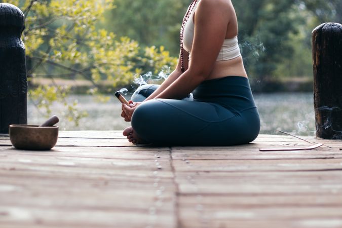 Young woman meditating and doing yoga in nature