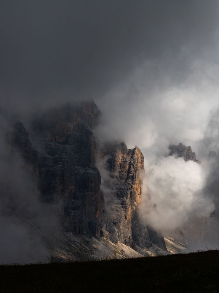 Mountain surrounded by dark clouds