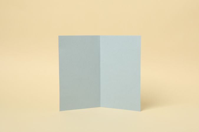 Light gray cardboard on beige background, space for text