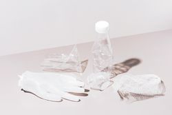 Various crushed plastic items on neutral background
