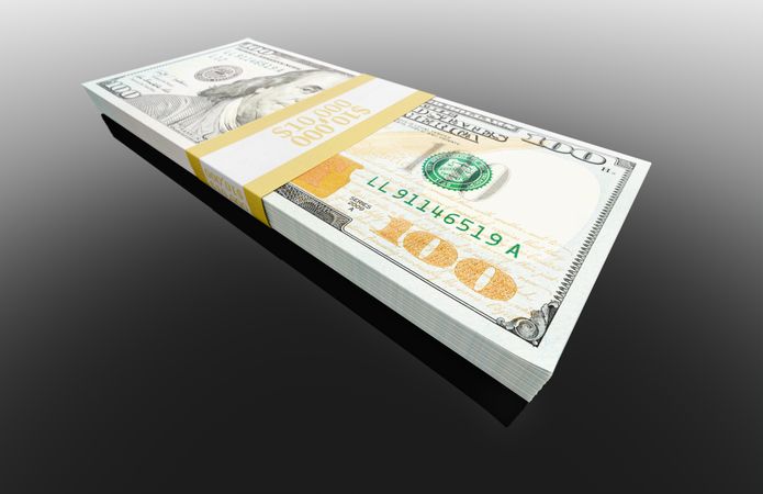 Stack of Ten Thousand Dollars of One Hundred Dollar Bills on Dark Reflective Surface.